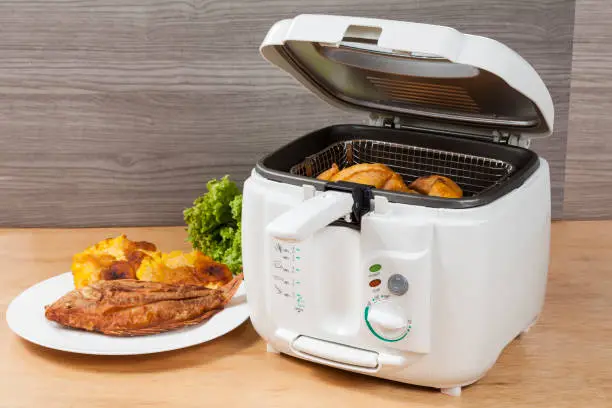 Household kitchen - A white automatic electric fryer pot.