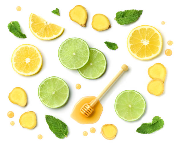 composition of honey spoon, ginger and citrus fruit slices