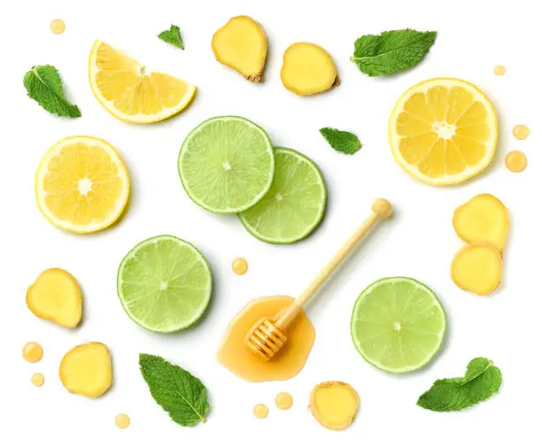 Photo of composition of honey spoon, ginger and citrus fruit slices