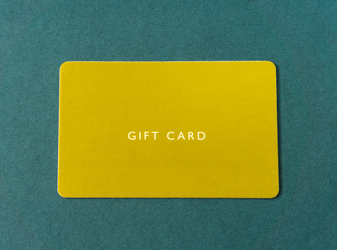 Gift card on green background. yellow gift card.