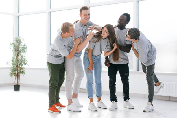 istock cheerful young business team standing in new office 1282476027