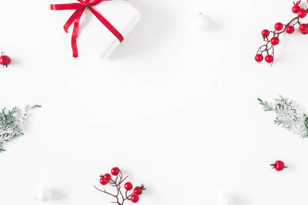 istock Christmas composition. Frame made of gift, snowflakes, fir tree branches and red berries on white background. Christmas, winter, new year concept. Flat lay, top view, copy space 1282476991