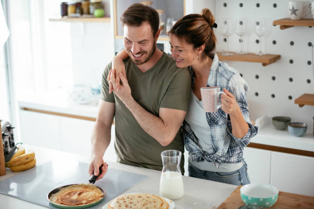 istock Husband and wife making pancakes at home 1282477009
