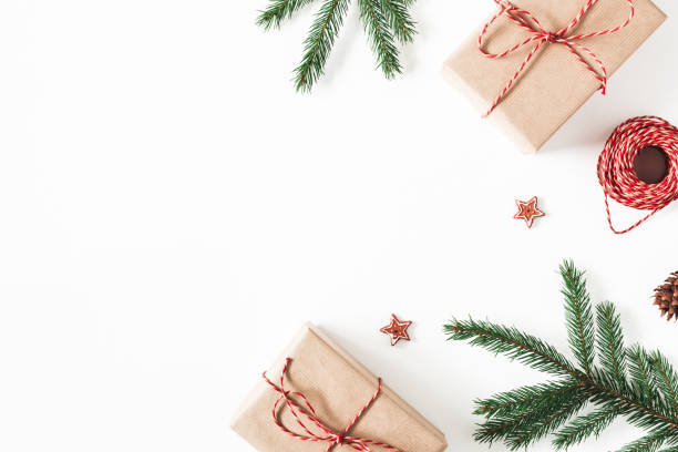 Christmas composition. Christmas gifts, fir tree branches, decorations on white background. Flat lay, top view, copy space