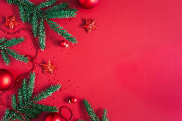 istock Christmas composition. Christmas red decorations, fir tree branches on red background. Flat lay, top view, copy space 1282477032
