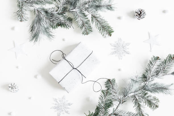 istock Christmas composition. Gift box, fir tree branches, decorations on white background. Christmas, winter, new year concept. Flat lay, top view, copy space 1282477071