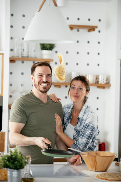 istock Husband and wife making pancakes at home 1282478644