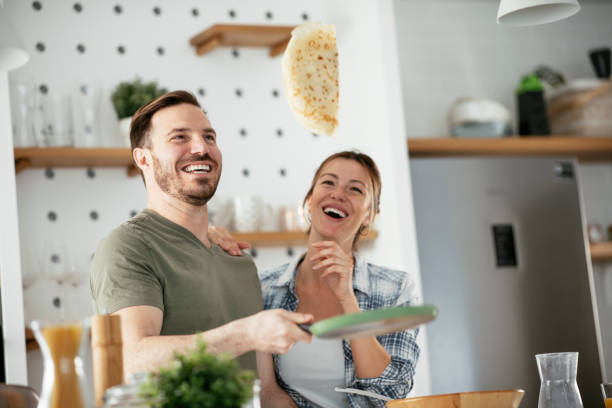 istock Husband and wife making pancakes at home 1282478718