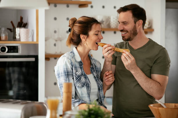 istock Husband and wife making pancakes at home 1282478731