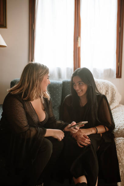 istock Two young women looking at the smart phone 1282479800