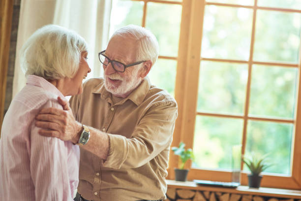 istock Smiling senior couple having fun together in their house 1282480340