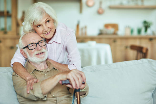 istock Smiling senior wife hugging her husband at home 1282481191