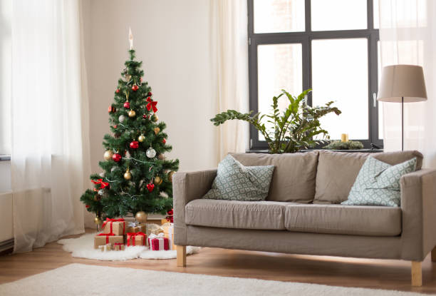 istock christmas tree, gifts and sofa at cozy home 1282481582