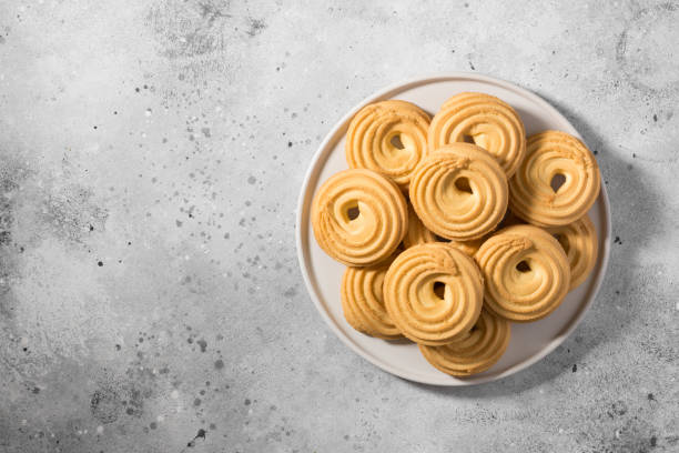 istock Cookies on a white ceramic plate on the gray kitchen table. Top view with copy space 1282481623