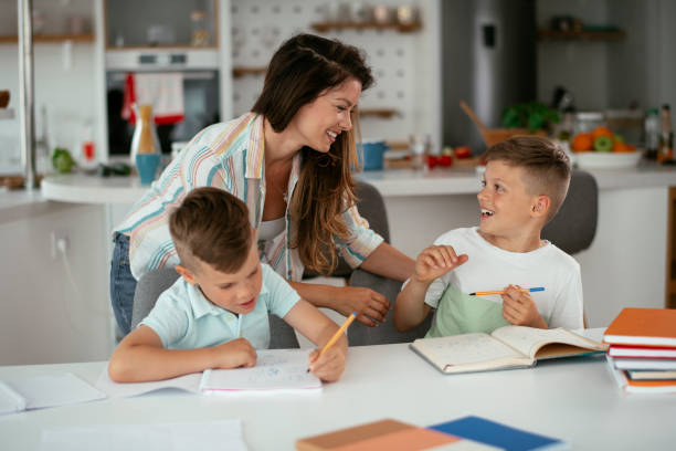 istock Mother helping her son with homework at home. 1282482543