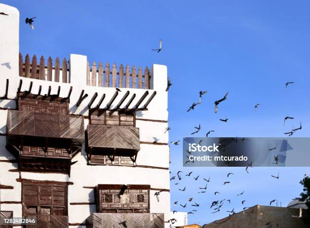 Al Balad District Pigeons And Hedjazi Architecture Arabian Balconies Suq Al Alawi Historic Jeddah Saudi Arabia Unesco World Heritage Site Stock Photo - Download Image Now