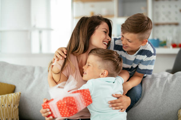 istock Two young sons are giving their mother a gift 1282484768