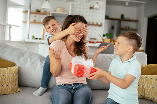 istock Two young sons are giving their mother a gift 1282485510