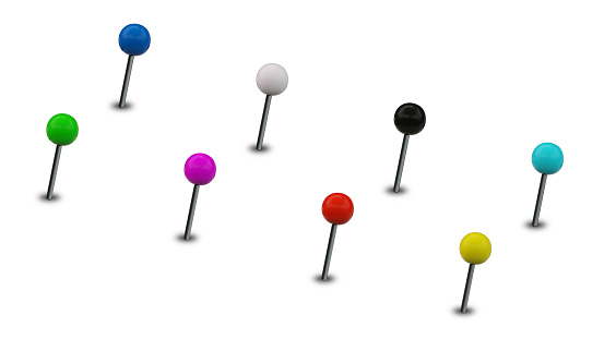 A group of spherical colorful thumbtack straight pins isolated on white background for further composition or derivative work.