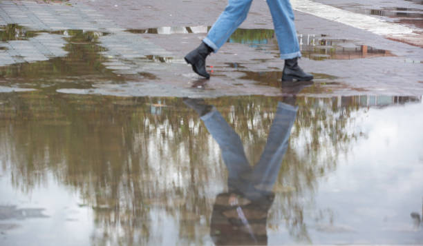 istock walking on a rainy day in the puddle 1282485843