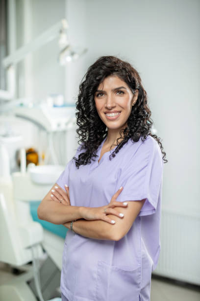 istock Dentist standing in office, arms crossed 1282486991