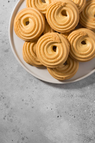 istock Cookies on a white ceramic tray on the gray kitchen table. Top view with copy space 1282487145