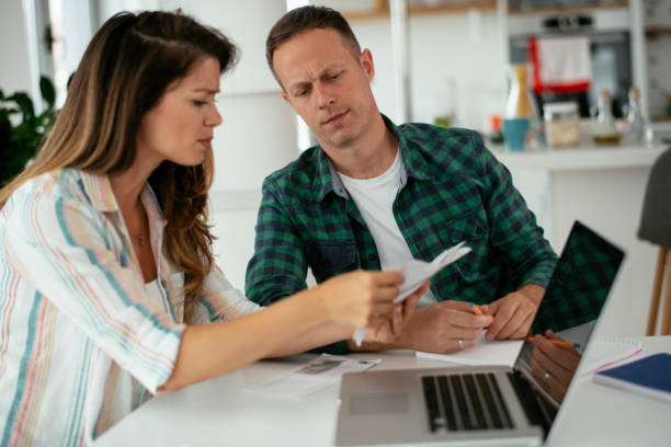 istock Husband and wife preparing bills to pay. 1282488728