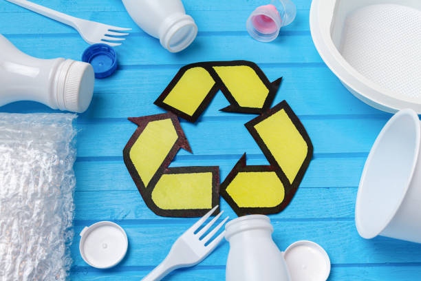 istock white plastic waste with recycling on blue background. Eco concept with copy space 1282489956