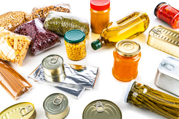 istock Non-perishable food: canned goods, conserves, sauces and oils on white background. Copy space 1282490202