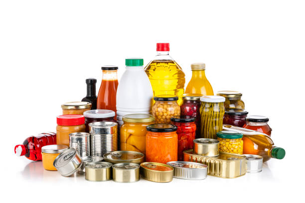 Non-perishable food: canned goods, conserves, sauces and oils isolated on white background Non-perishable food: front view of a large group of multicolored unbranded canned goods, conserves, sauces and oils isolated on white background. High resolution 42Mp studio digital capture taken with SONY A7rII and Zeiss Batis 40mm F2.0 CF lens canned food stock pictures, royalty-free photos & images