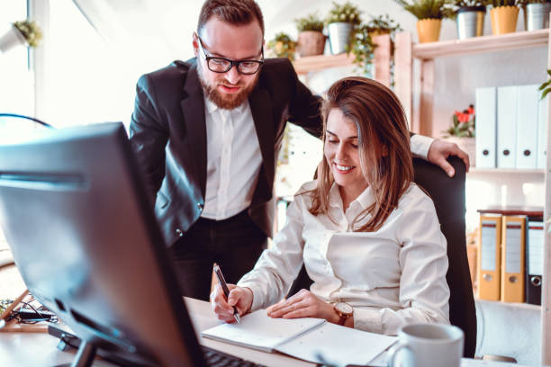 istock Business Couple Devising Marketing Strategy Together In Office 1282492122