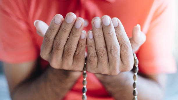 Close up Religious muslim man praying with prayer beads beads in hand Close up Religious muslim man praying with prayer beads beads in hand mullah photos stock pictures, royalty-free photos & images