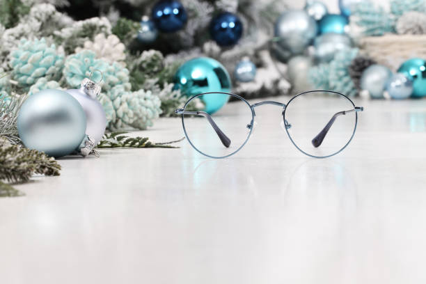 istock christmas eyeglasses blue spectacles isolated on white table with balls and decorations useful as a greeting gift card template with copy space 1282493366