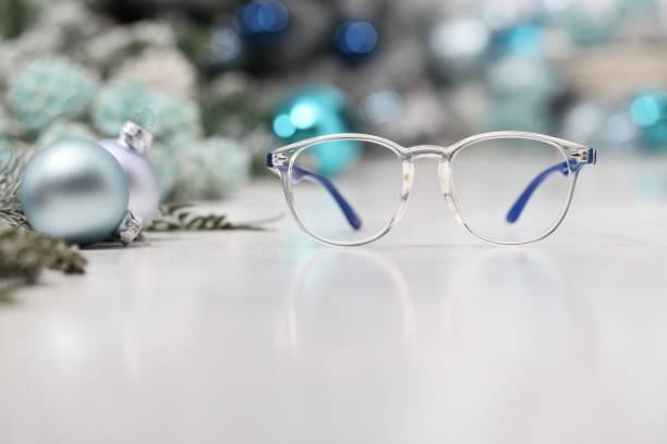 istock christmas eyeglasses blue spectacles isolated on white table with balls and decorations useful as a greeting gift card template with copy space 1282493372