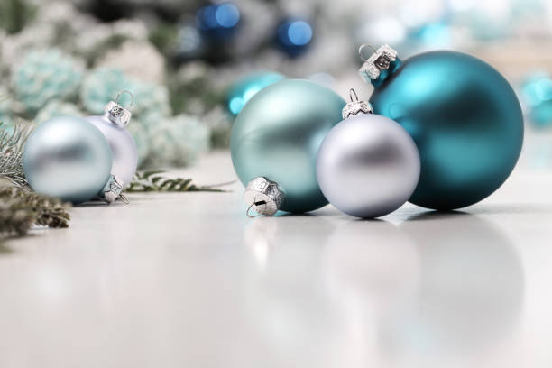 istock merry christmas background, silver and blue christmas balls and decorations on white table, useful as a greeting card template with copy space 1282493375