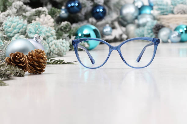 istock christmas eyeglasses blue spectacles isolated on white table with balls and decorations useful as a greeting gift card template with copy space 1282493377