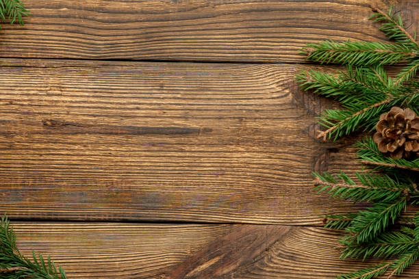 istock Fir, spruce branches on brown wooden background with copy space 1282493587