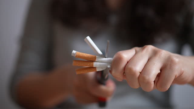 Slow motion cutting a cigarette