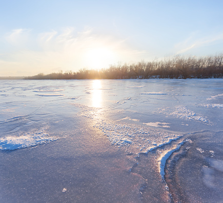 sunset over a frozen lake