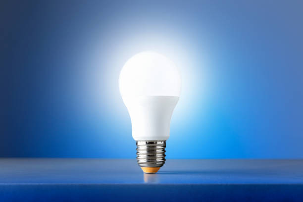 istock Light bulb on blue background. Concept of new ideas. 1282496377