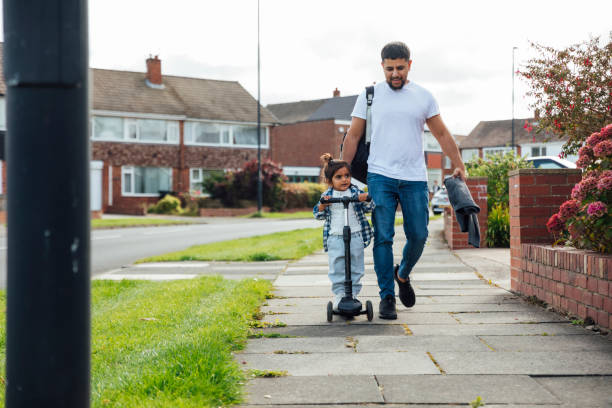 istock Father and Son Walking Down the Street 1282496642