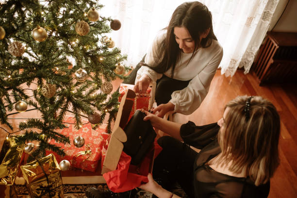 istock Two young women opening christmas presents 1282501683