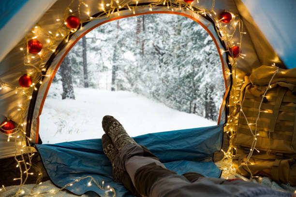 istock A man lying in a tent decorated with Christmas lights 1282501860