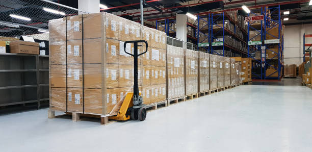 Warehouse with cardboard boxes inside on pallets racks, logistic center. Huge, large modern warehouse. Warehouse filled with cardboard boxes on shelves, boxes stand on pallets