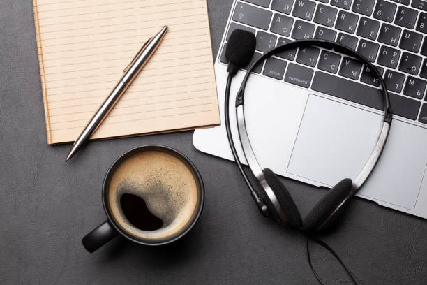 istock Office desk with headset and laptop 1282504202