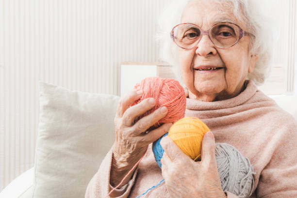 istock Smiling eldery woman holding colorful laces balls 1282504328