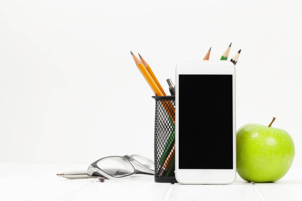 istock Workplace with smartphone, supplies and apple 1282504400