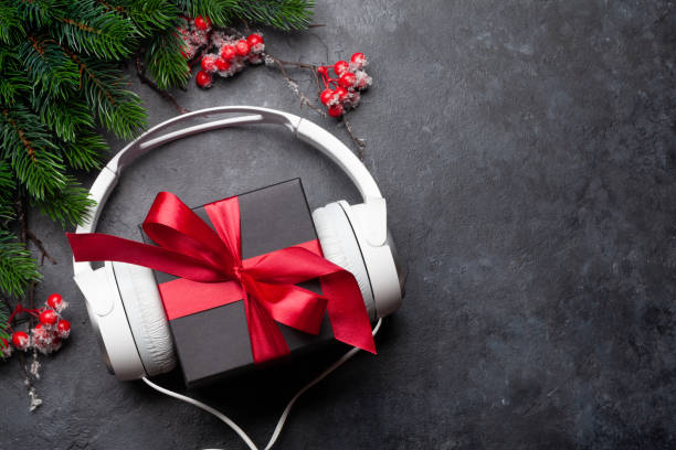 christmas greeting card with headphones and gift box - celebratory holiday audio imagens e fotografias de stock