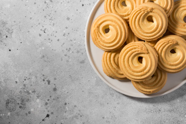 istock Cookies on a white ceramic tray on the gray kitchen table. Top view with copy space 1282505643