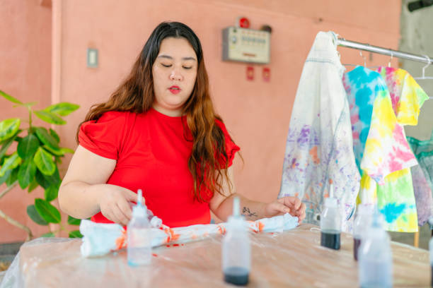istock Young woman making tie dye indoors 1282505747